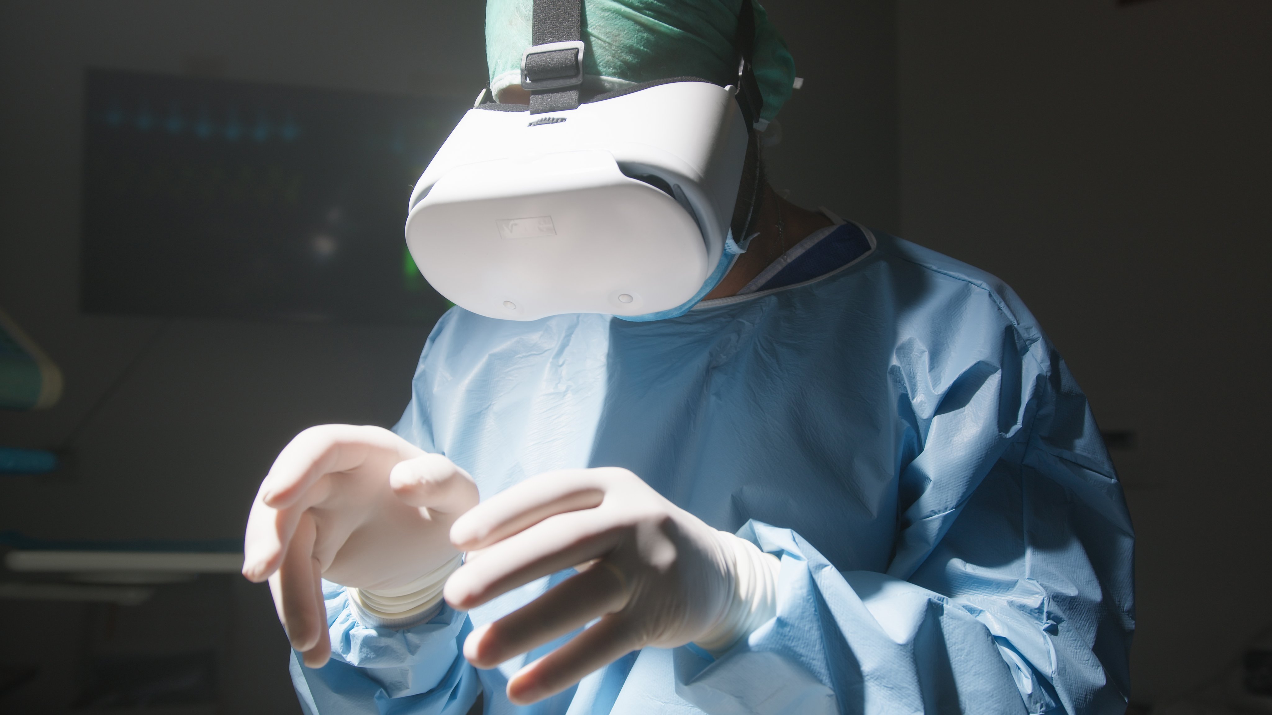 Surgeon wearing a virtual reality headset and surgical gown, representing augmented reality in ophthalmic training and surgery