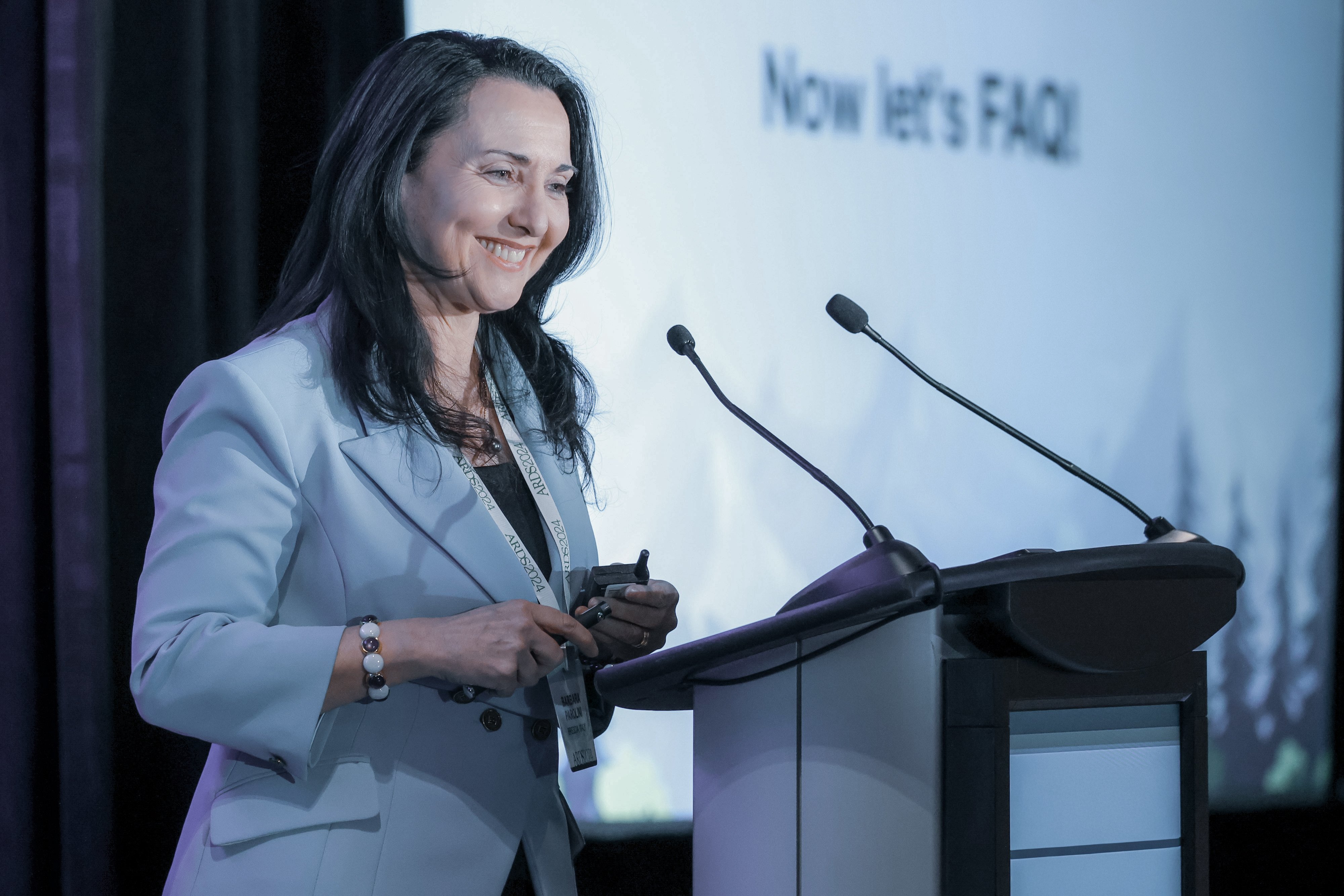 Ophthalmologist speaking at a conference podium during a professional eye care event