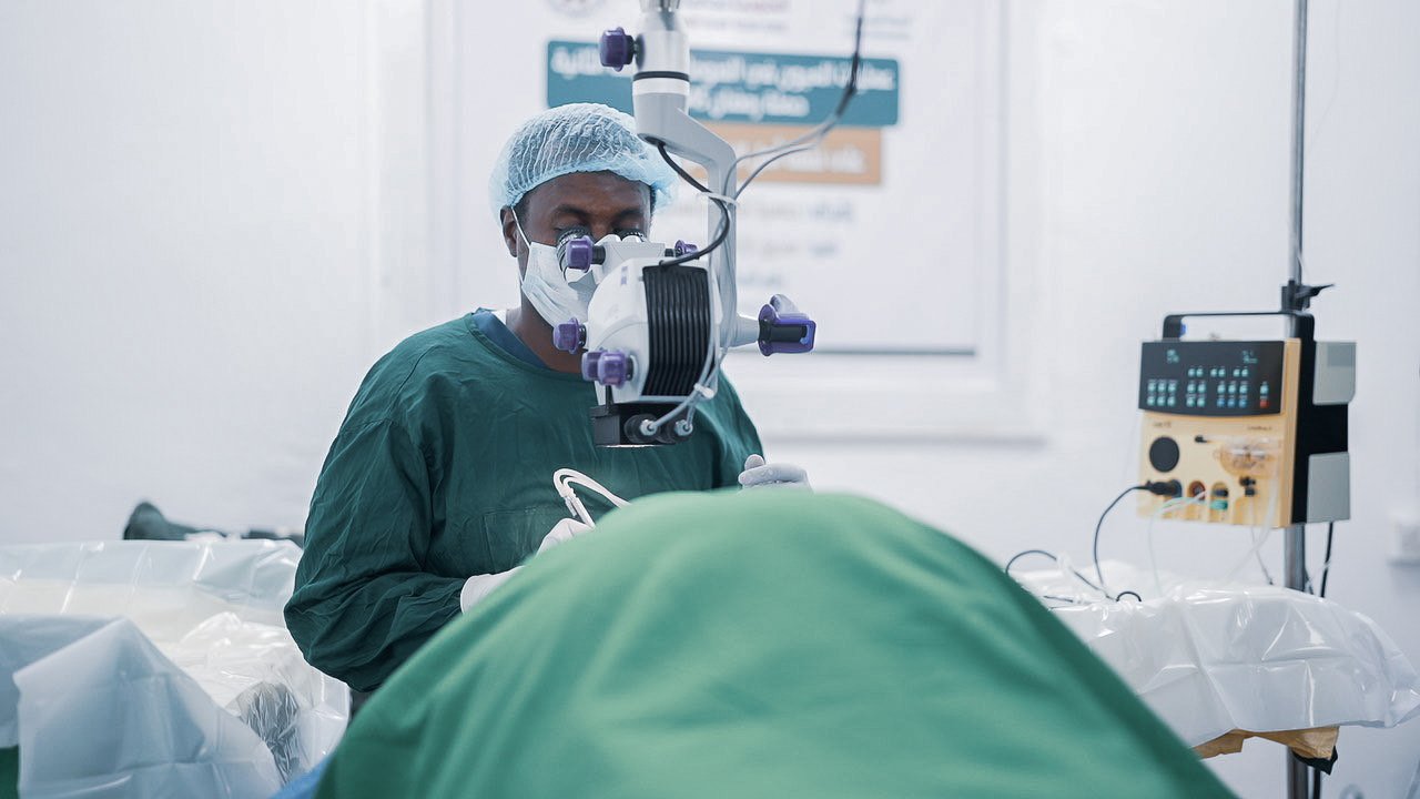 Surgeon performing an eye procedure at Hayle Eye Clinic with a CataRhex 3 surgical system in the operating room