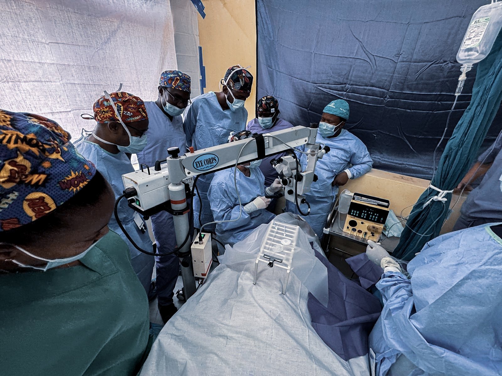 Ophthalmic outreach team performing cataract surgery in a temporary operating theatre in Tanzania using a surgical microscope and Oertli CataRhex 3 system