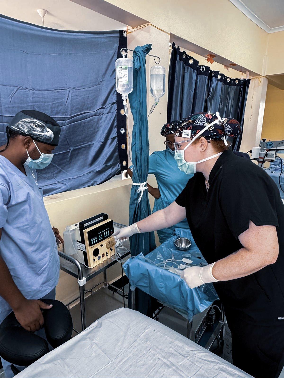 Ophthalmic outreach team performing cataract surgery in a temporary operating theatre in Tanzania using a surgical microscope and Oertli CataRhex 3 system