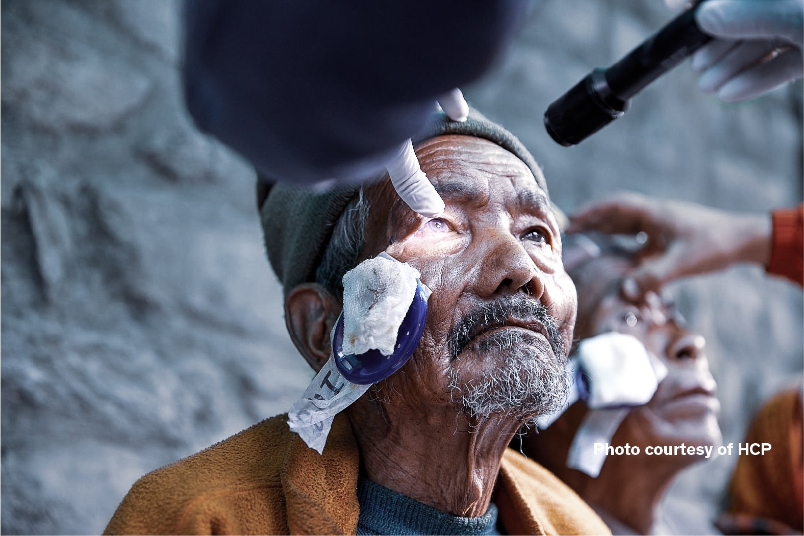 Patient receiving an eye examination after cataract surgery during the Cure Blindness Himalayan cataract outreach project
