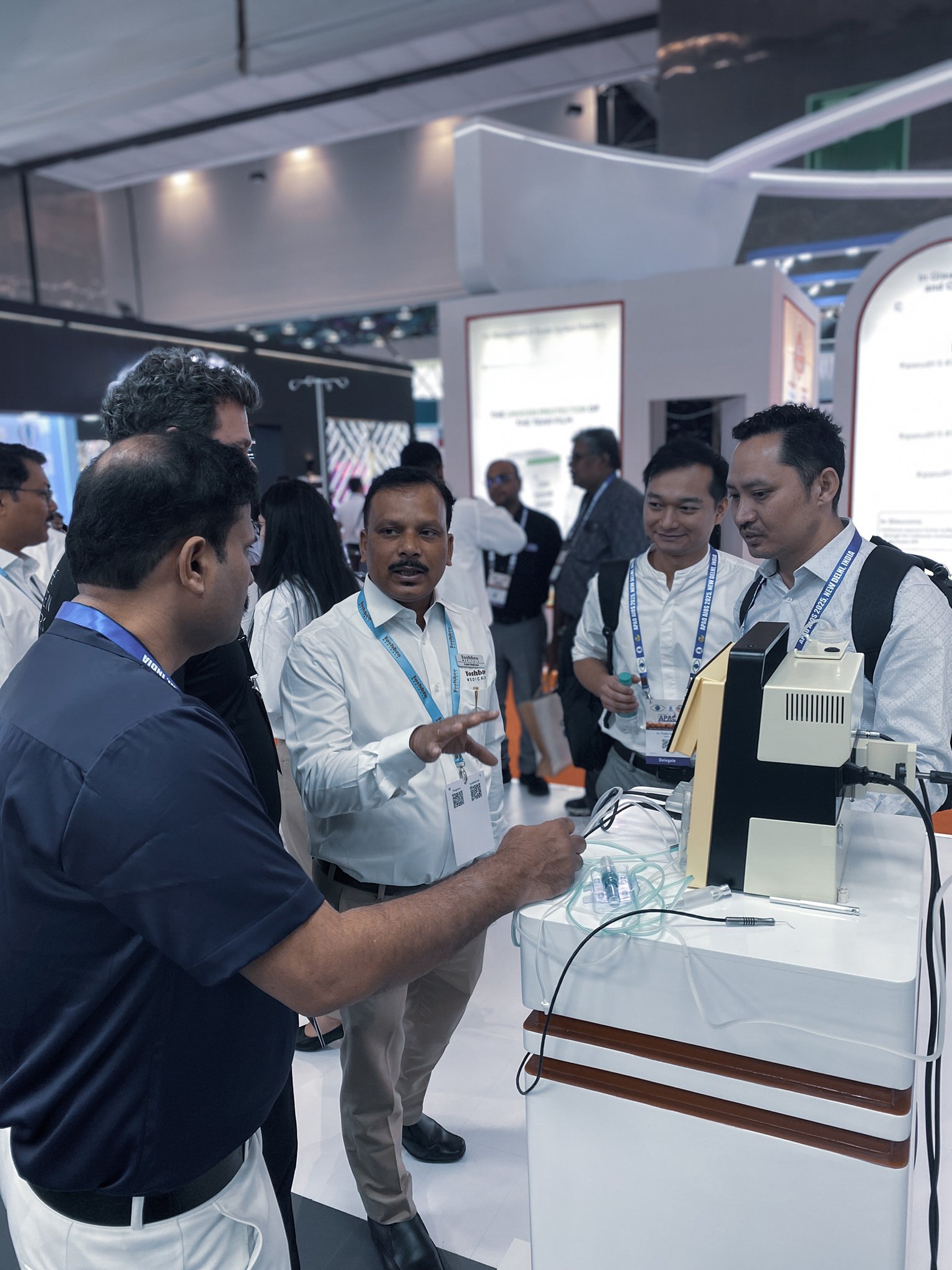 Visitors discussing an Oertli surgical platform at the APAO 2025 exhibition booth