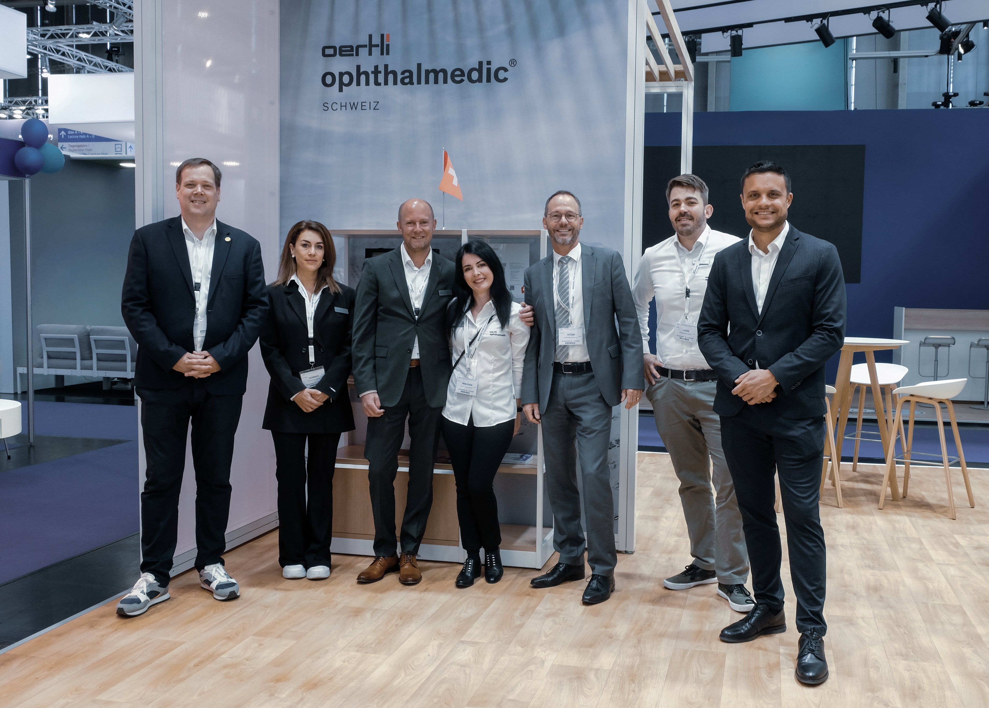 Oertli Mitarbeitende stehen gemeinsam am Messestand auf einer ophthalmologischen Fachmesse namens DOC