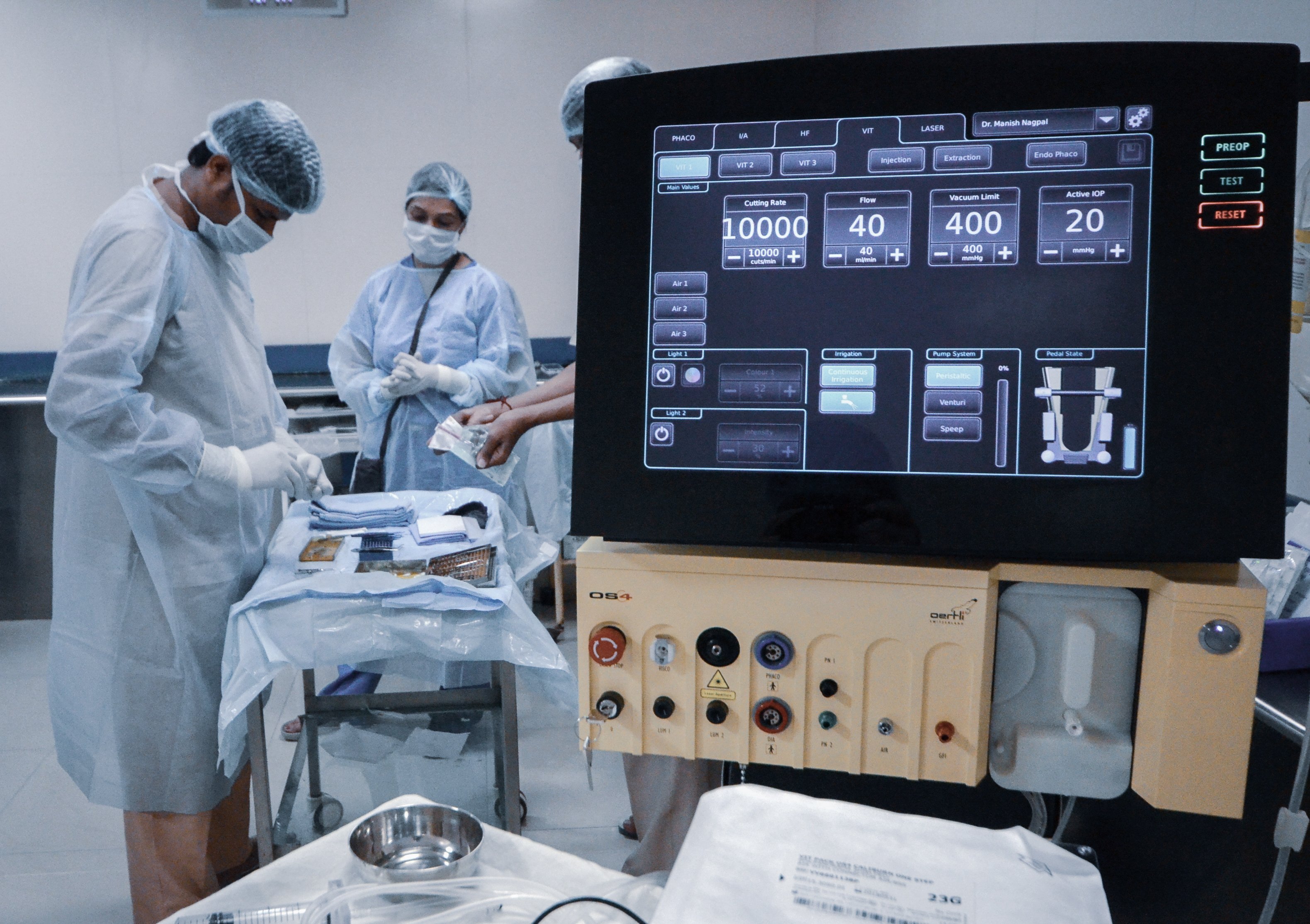 OS 4 surgical platform in an operating room while surgical staff prepare instruments for an ophthalmic procedure