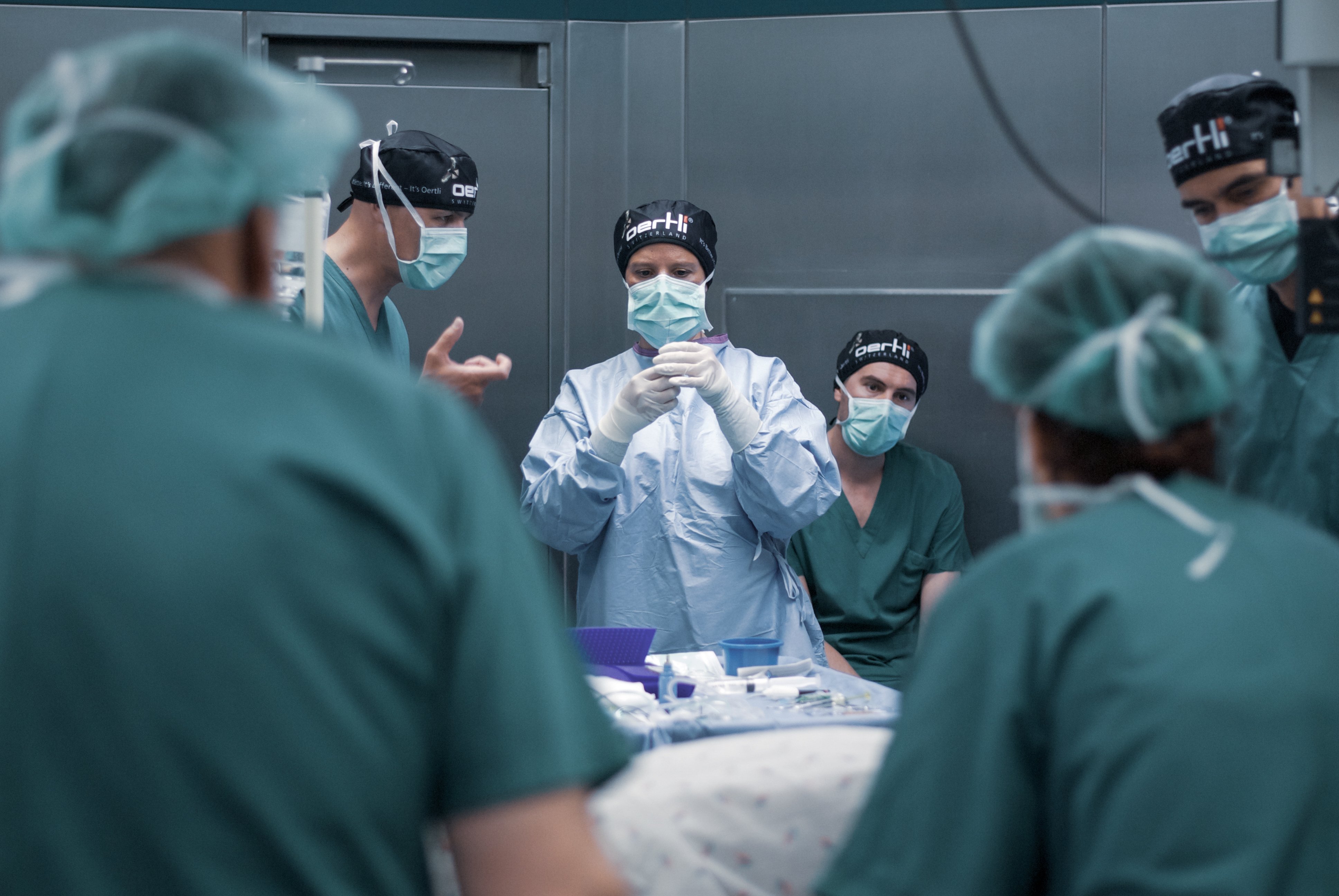 Surgical team in an operating room preparing for an ophthalmic procedure with Oertli equipment