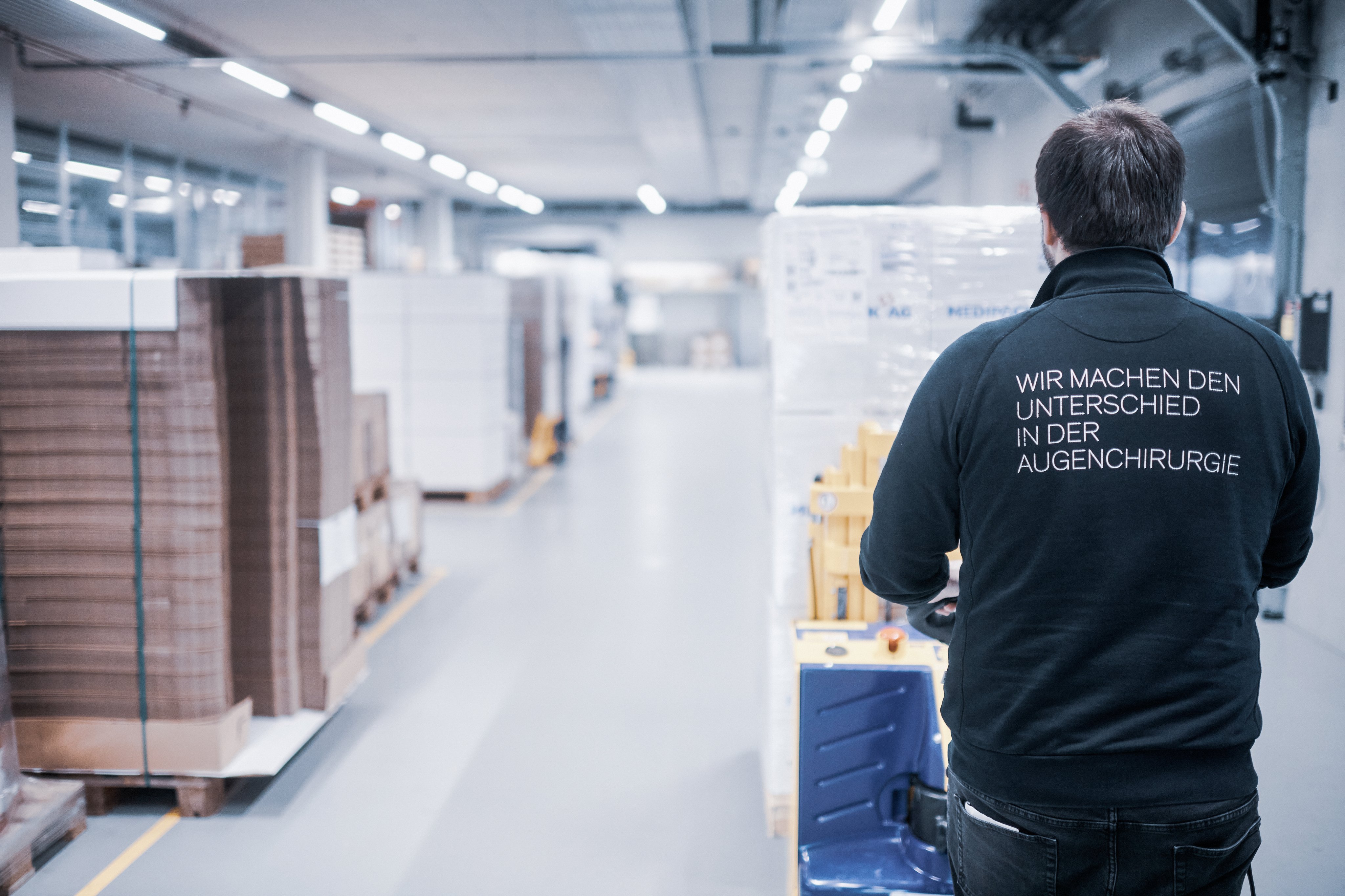 Oertli employee transporting goods through the logistics area