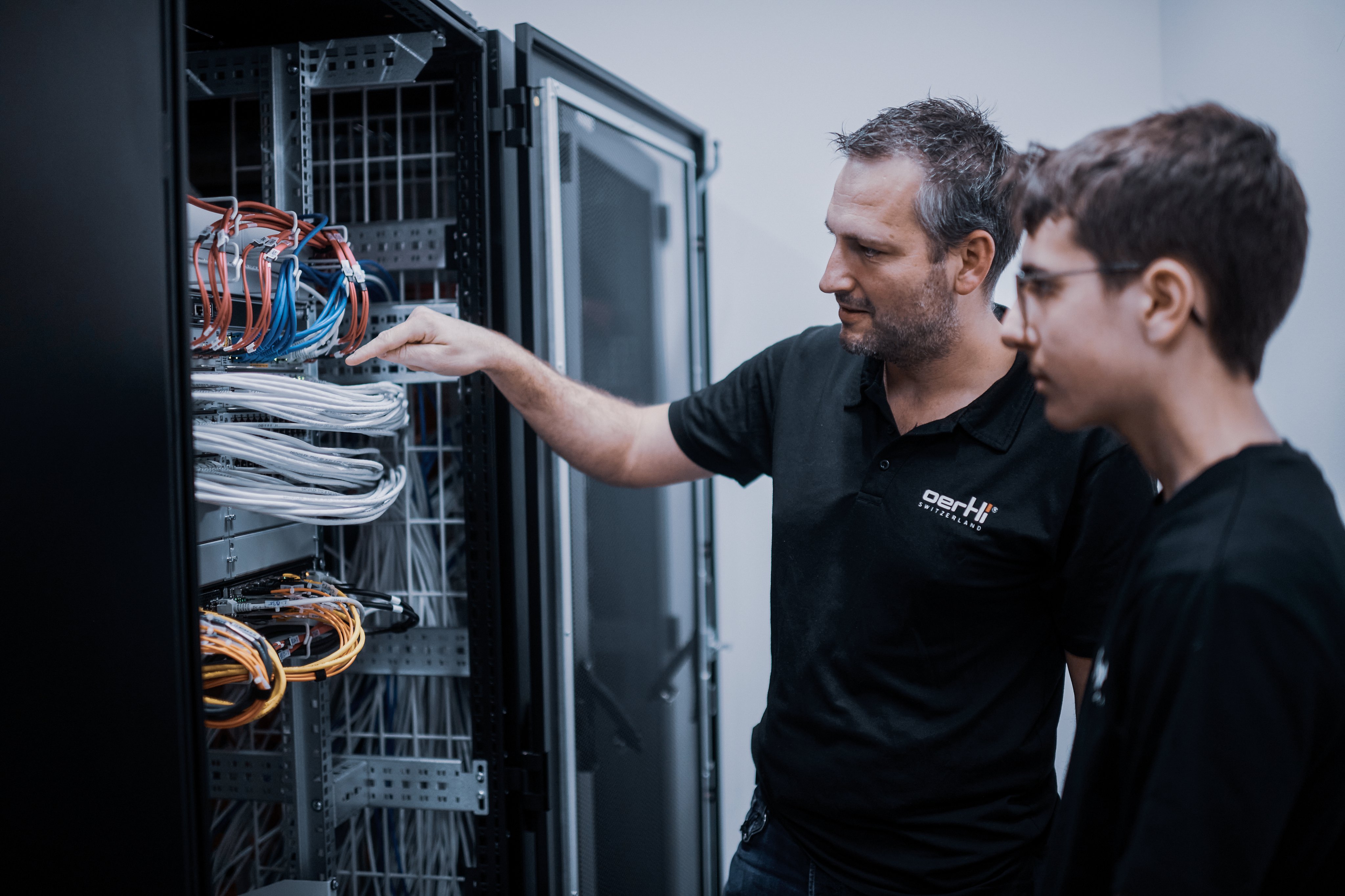 Lehrmeister erklärt seinem Lernenden die Struktur der IT-Servers