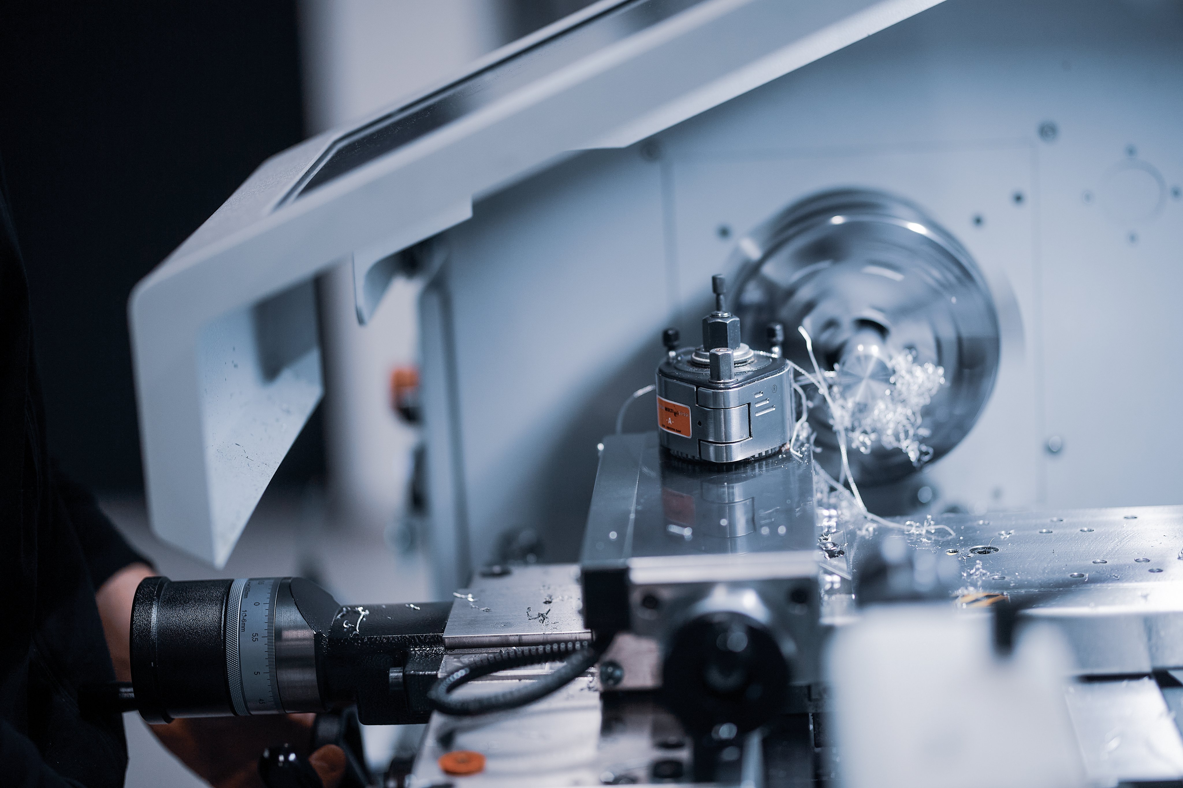 Close-up of precision machining with metal components and shavings in the Oertli manufacturing area