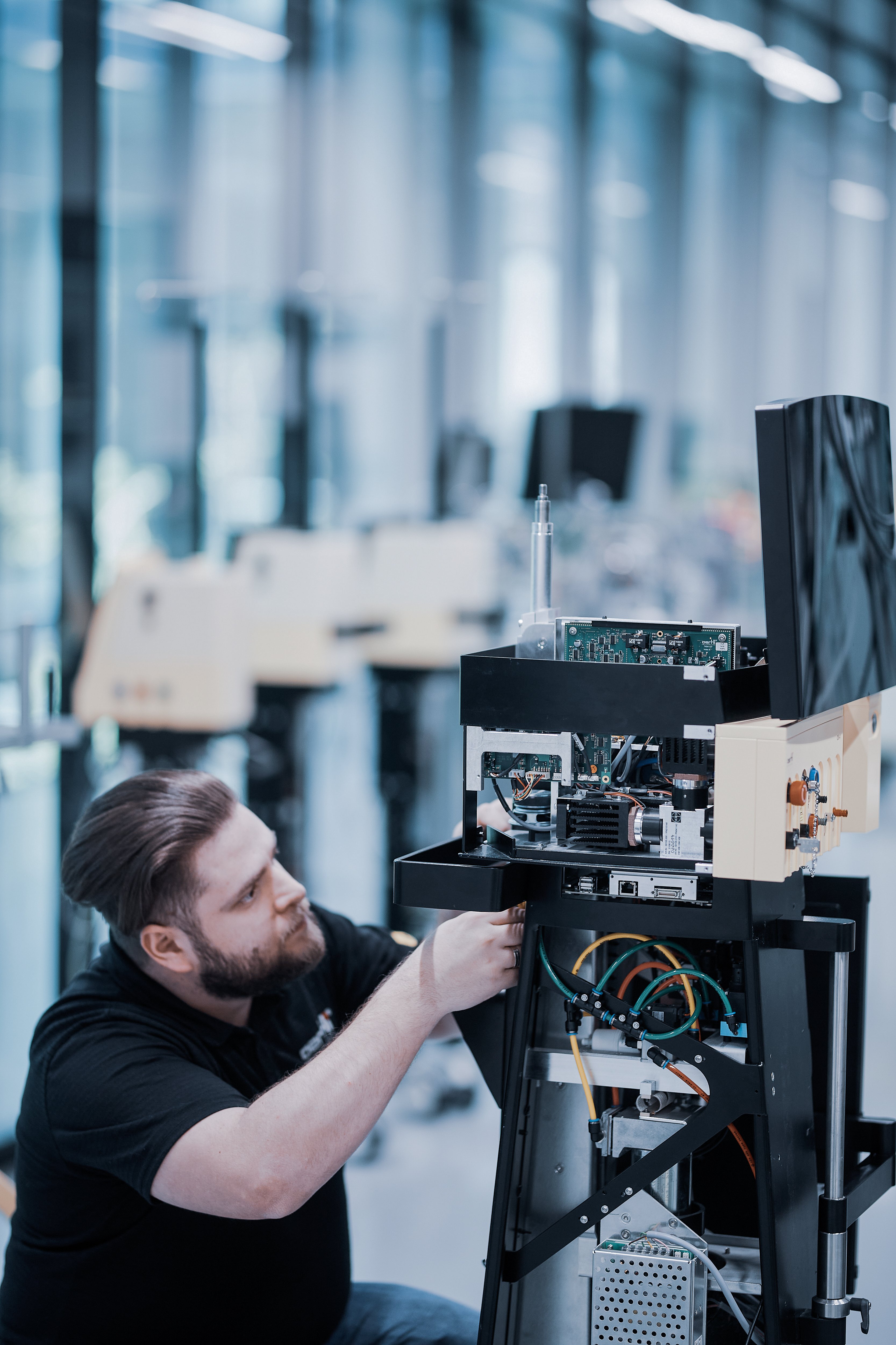Oertli employee servicing an ophthalmic surgical platform in a technical repair area