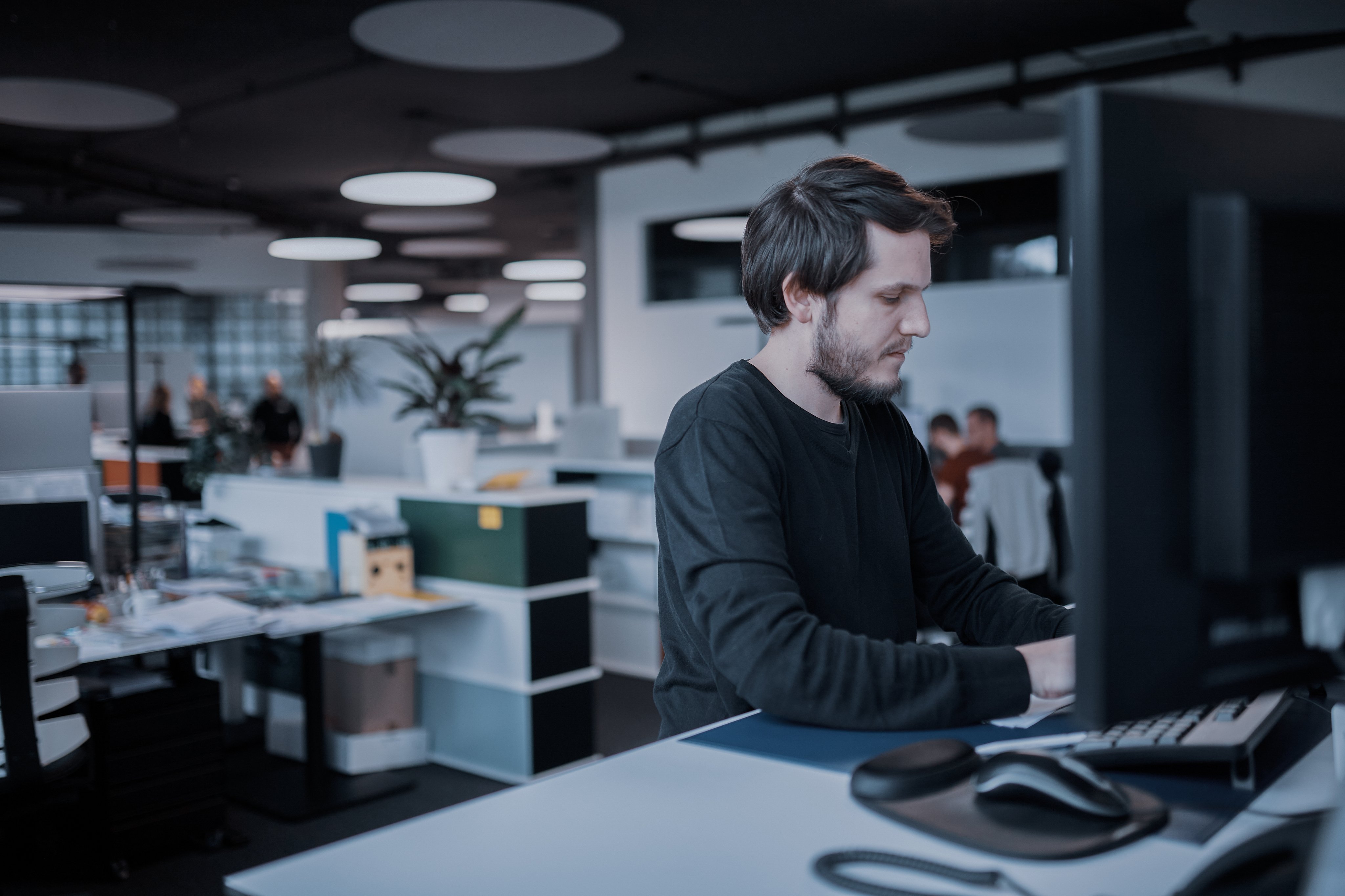Oertli employee working at a computer in the research and development office