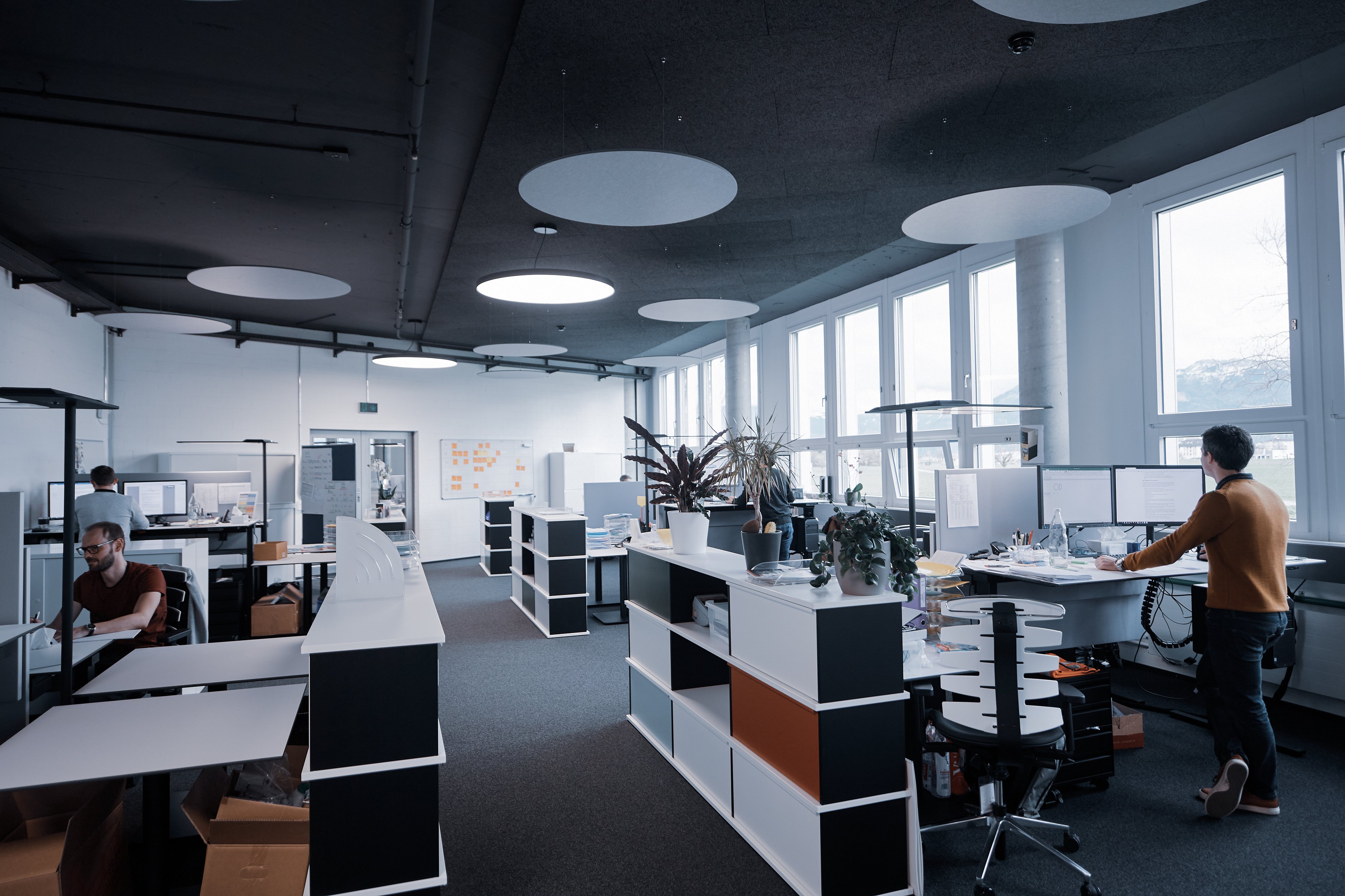 Open Oertli research and development office with employees working at computer workstations