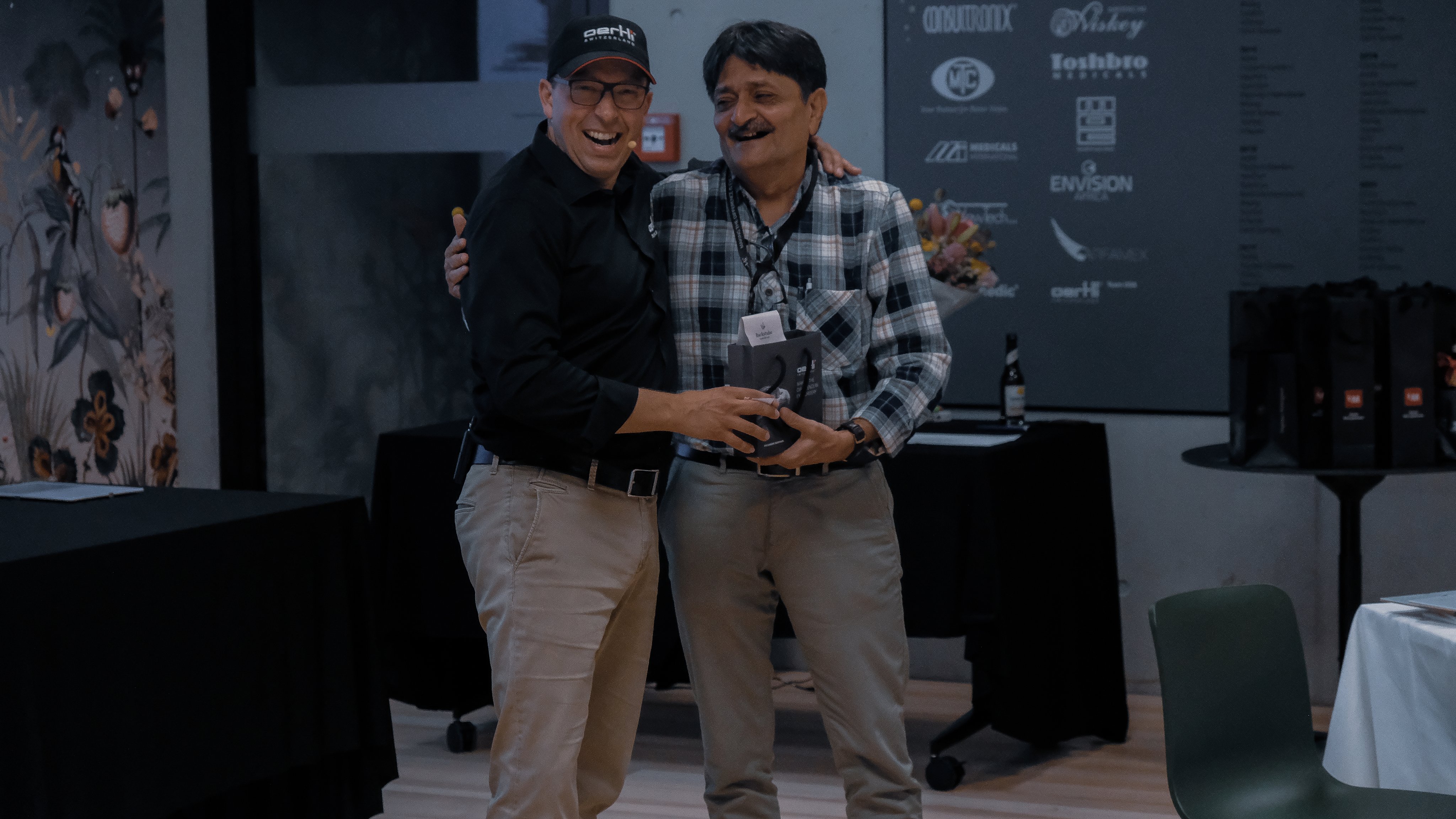 The CEO of Oertli and a participant at the Oertli Agents Meeting 2025 standing together while holding an award. The photograph was taken during an award ceremony at the international partner meeting