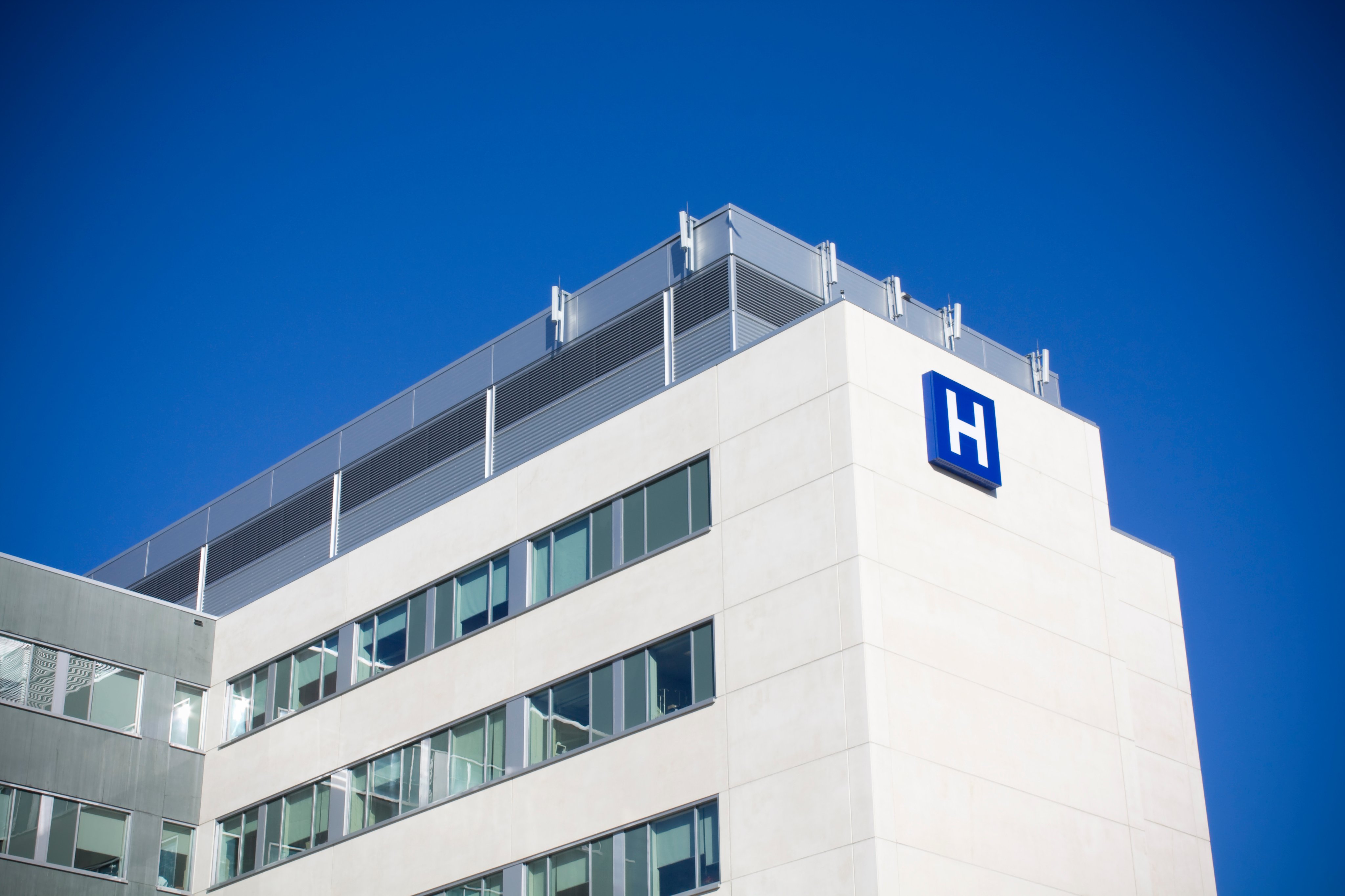 Modern hospital against deep blue sky shot in summer