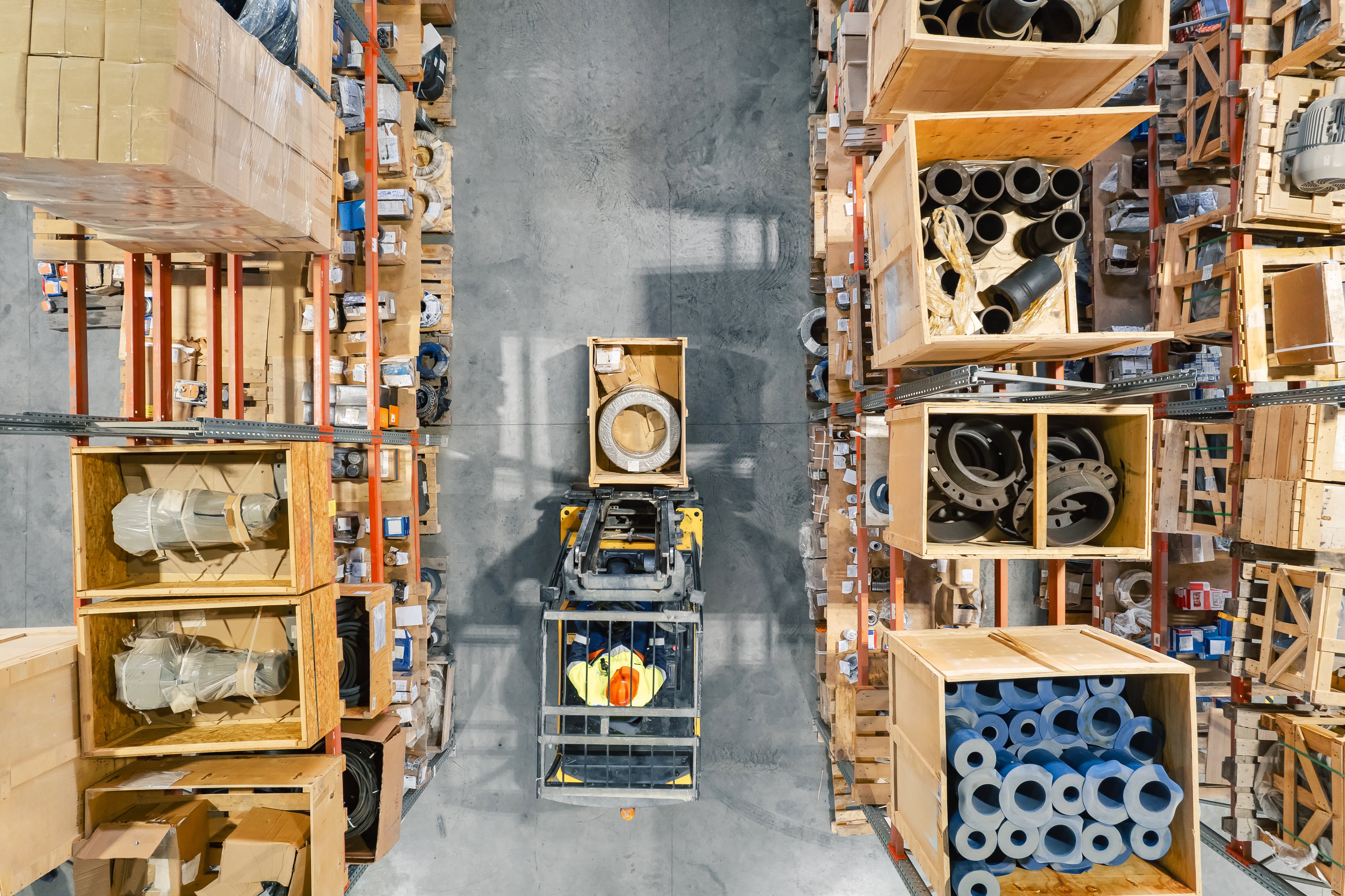 Top view of forklift in modern warehouse storage of mining factory, workshop space.