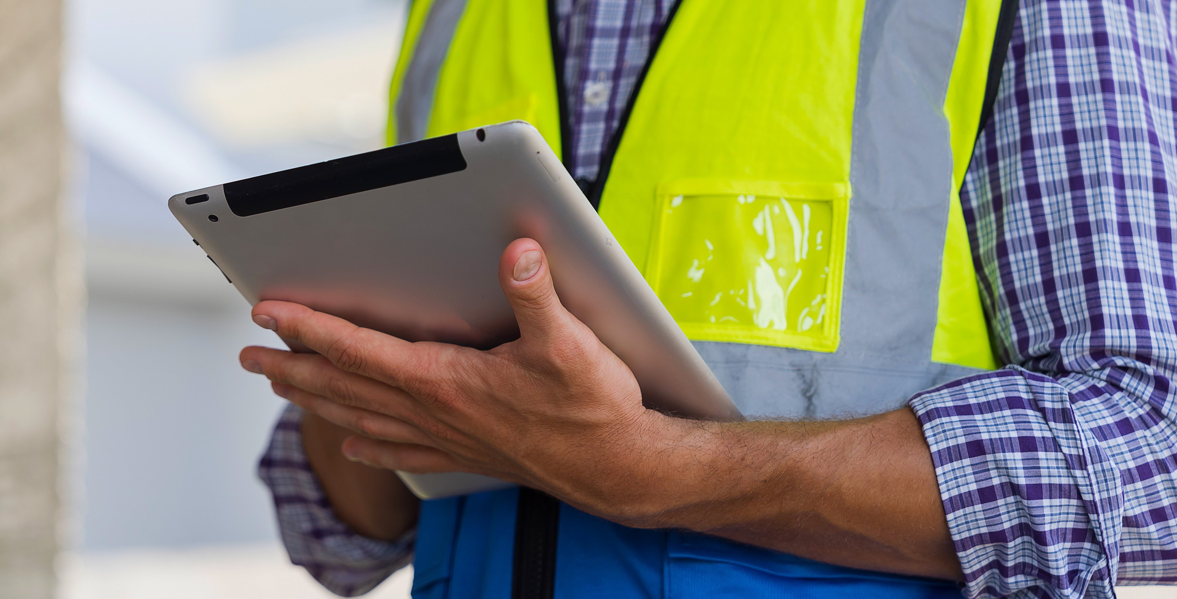 Construction site, hands holding tablet at housing estate projects under construction site. Banner of construction engineer working, planning, inspecting structure of architecture in construction site