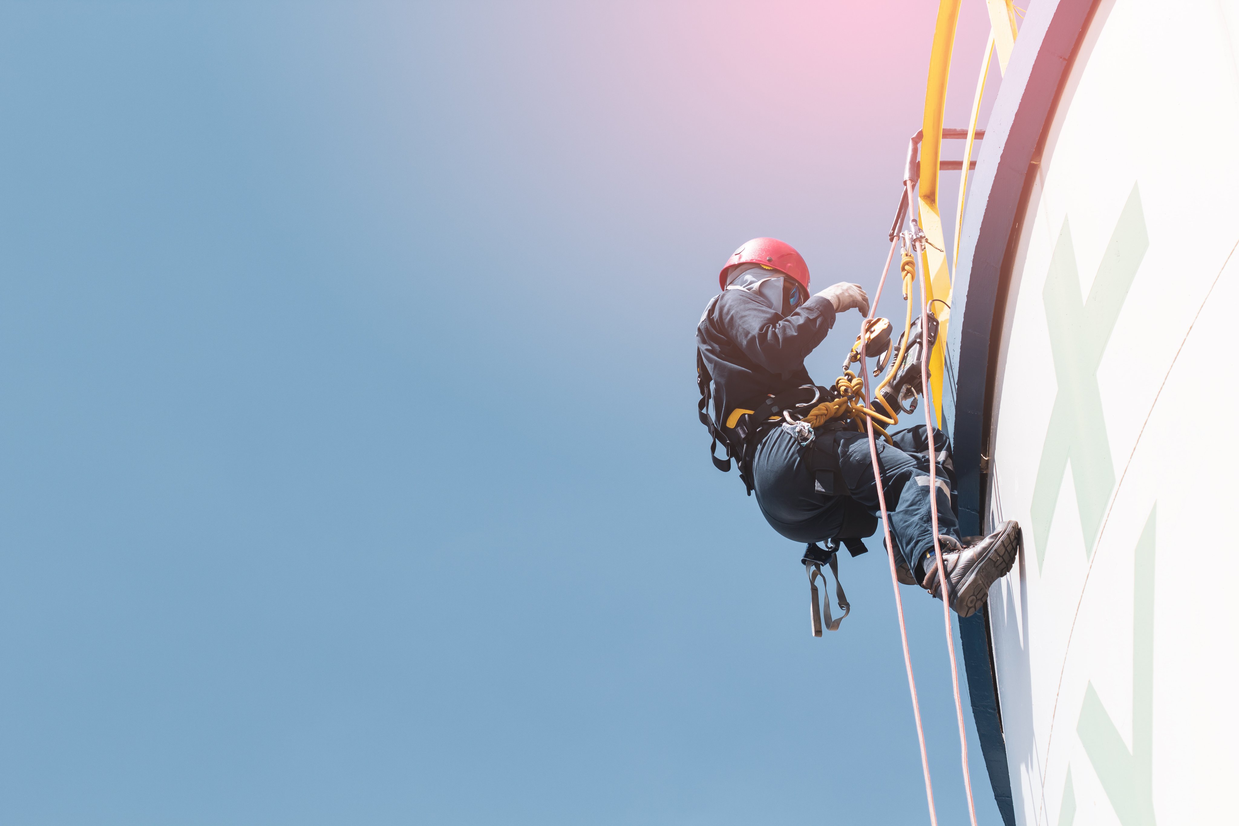 Male worker rope access  inspection of thickness storage  white tank industry