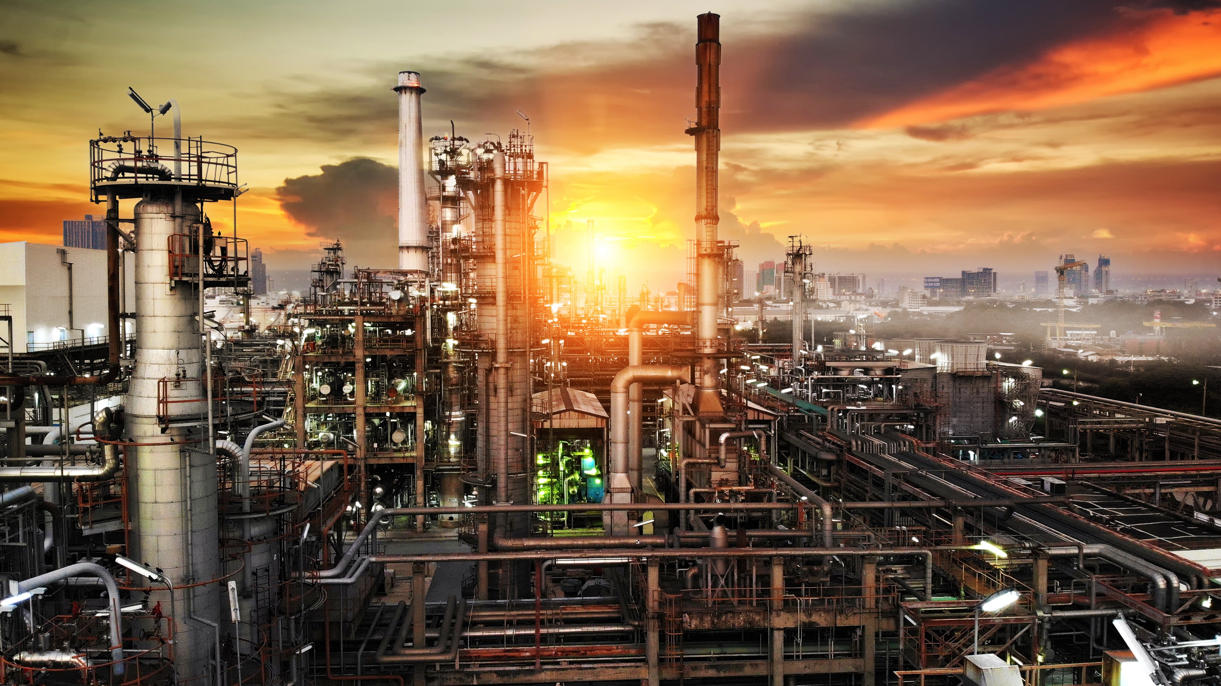 Oil and gas industry - refinery factory zone, The equipment of oil refining,Close-up of industrial pipelines of an oil-refinery petrochemical plant at sunset