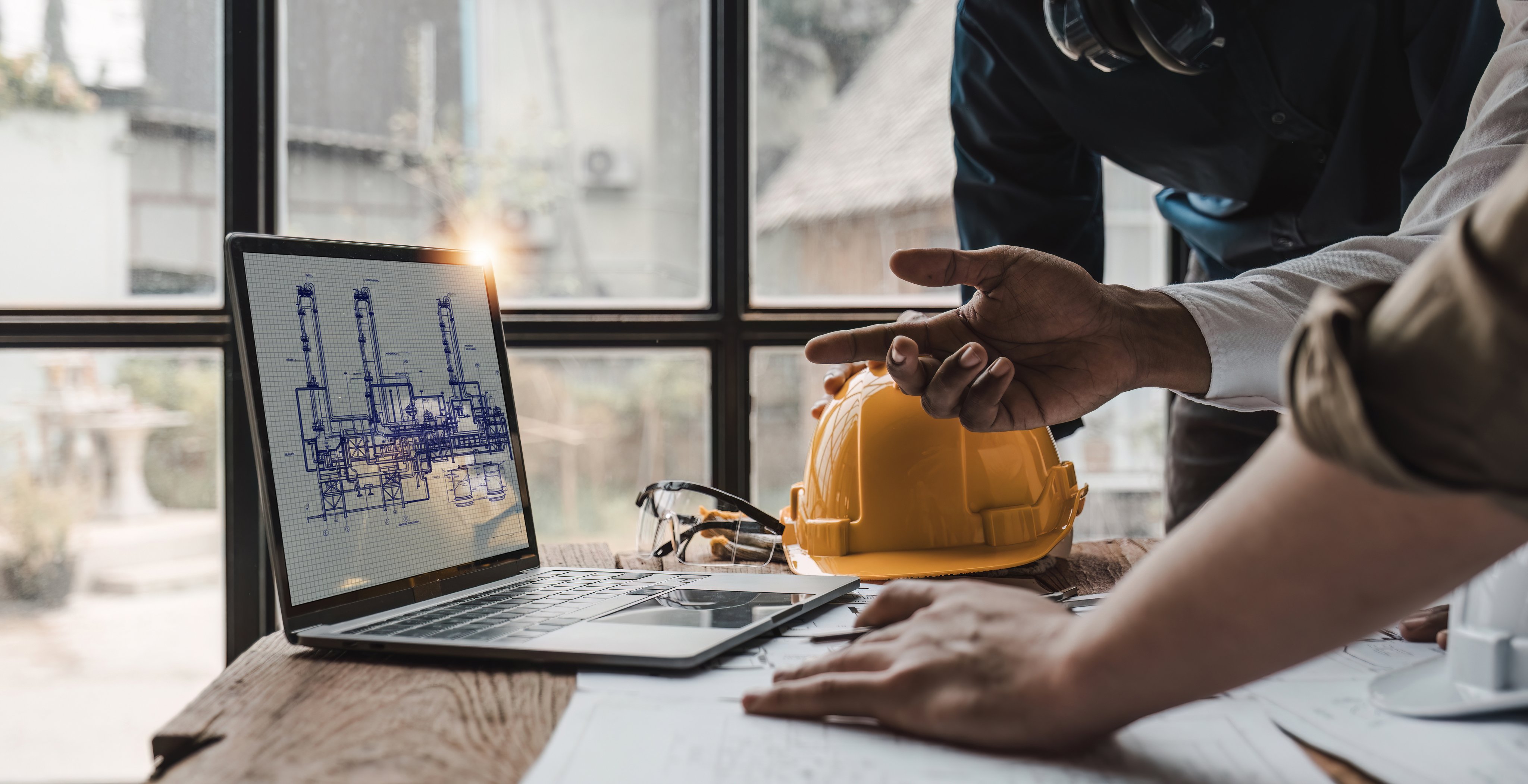 Civil engineer teams meeting working together wear worker helmets hardhat on construction site in modern city. Foreman industry project manager engineer teamwork. Asian industry professional team...