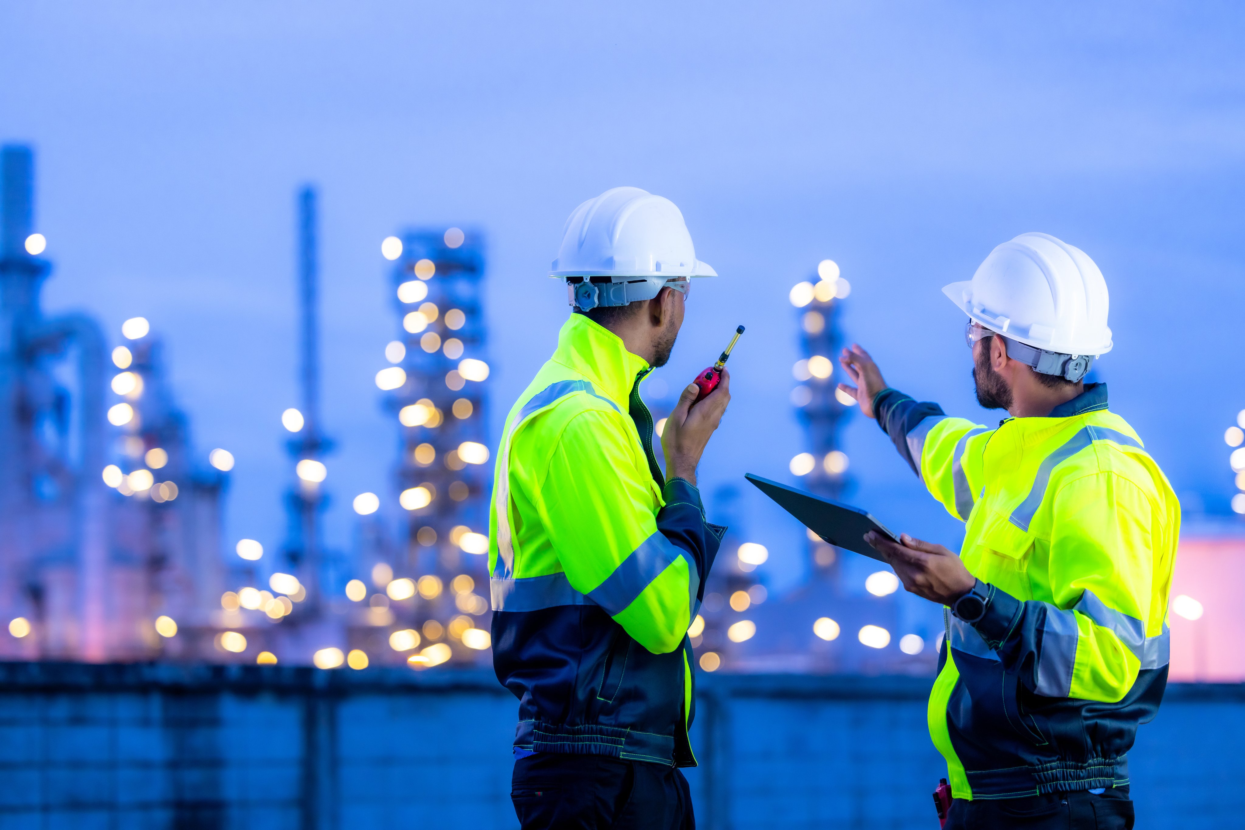 Team refinery engineer worker oil refinery petrochemical industrial plant at night, Team refinery engineer collaboration maintenance oil refinery plant, Teamwork engineer working petrochemical plant.