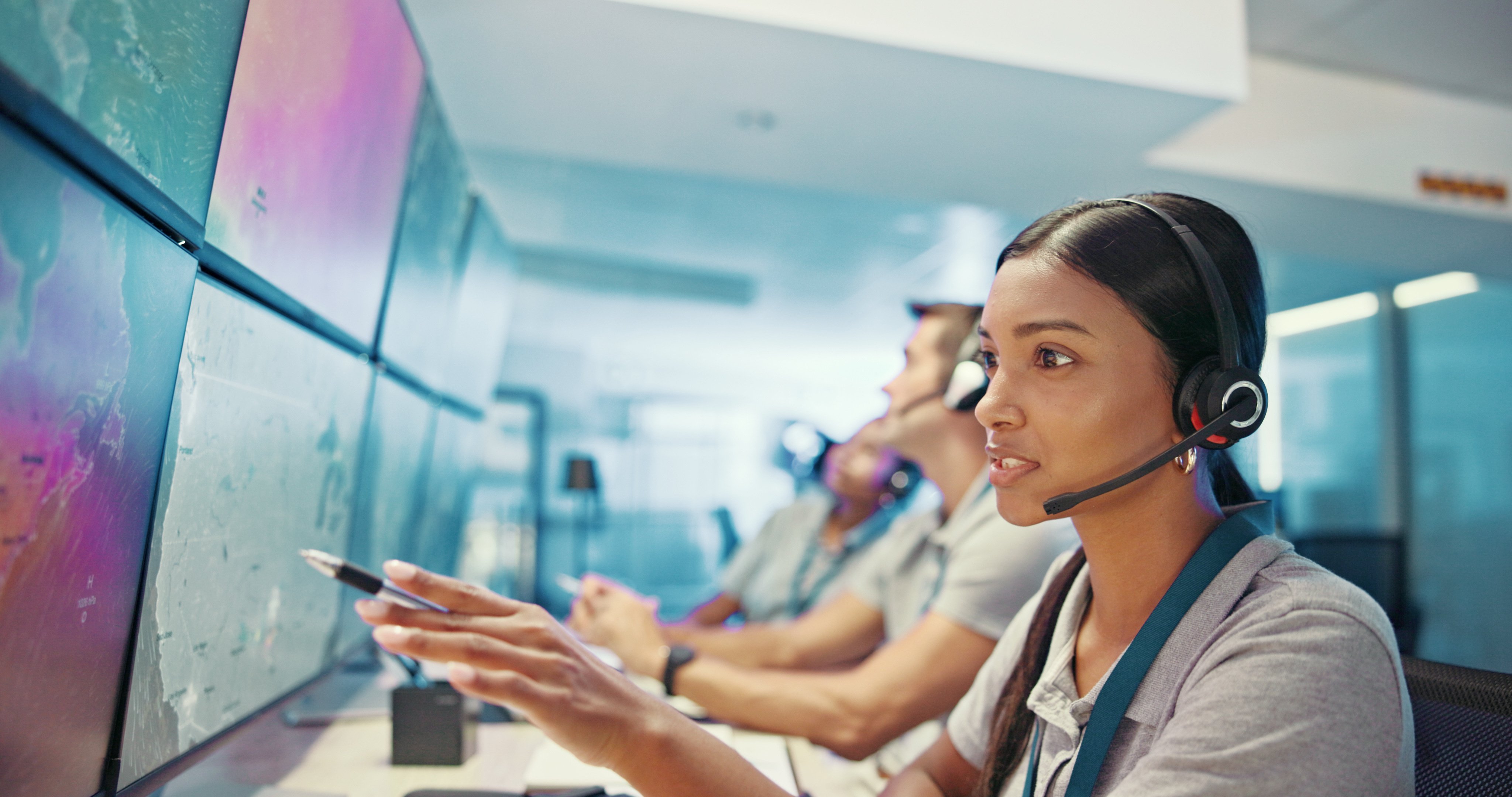Computer screen, talking or woman with headset in control room for weather pattern, satellite forecast or storm tracking. Meteorology, girl or pointing to radar system for climate monitor or planning.