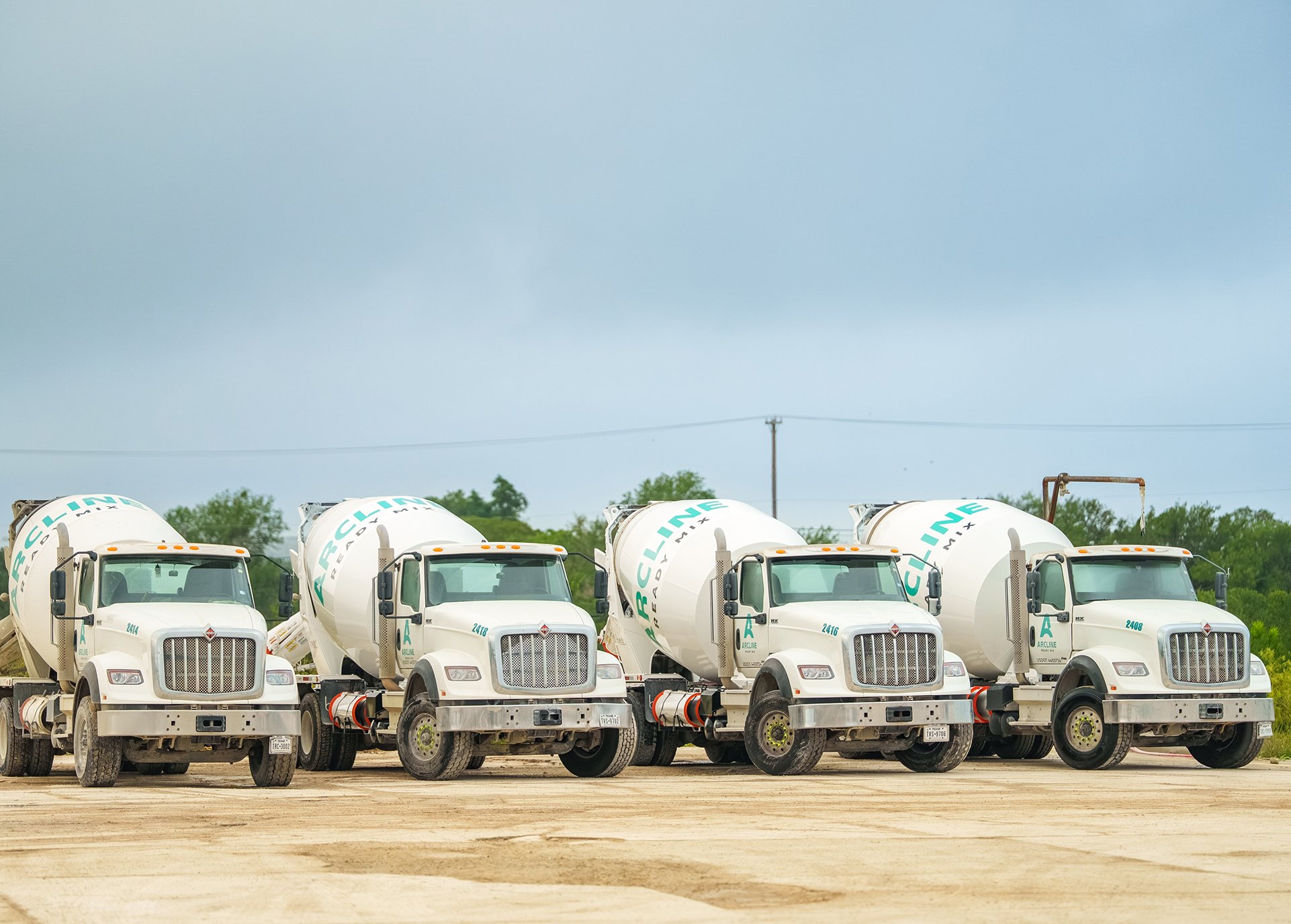 Arcline Ready Mix concrete mixer trucks lined up at a South Texas batch plant