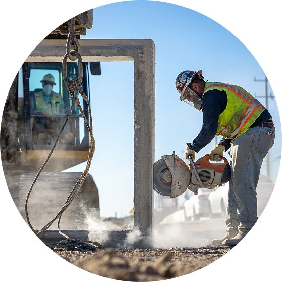 Construction worker using a concrete saw on a jobsite