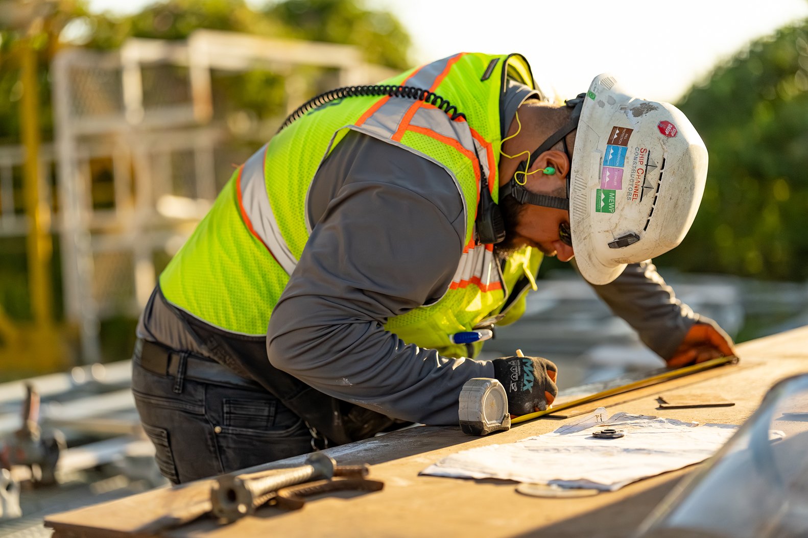 Zachry team member reviews plans at a construction site