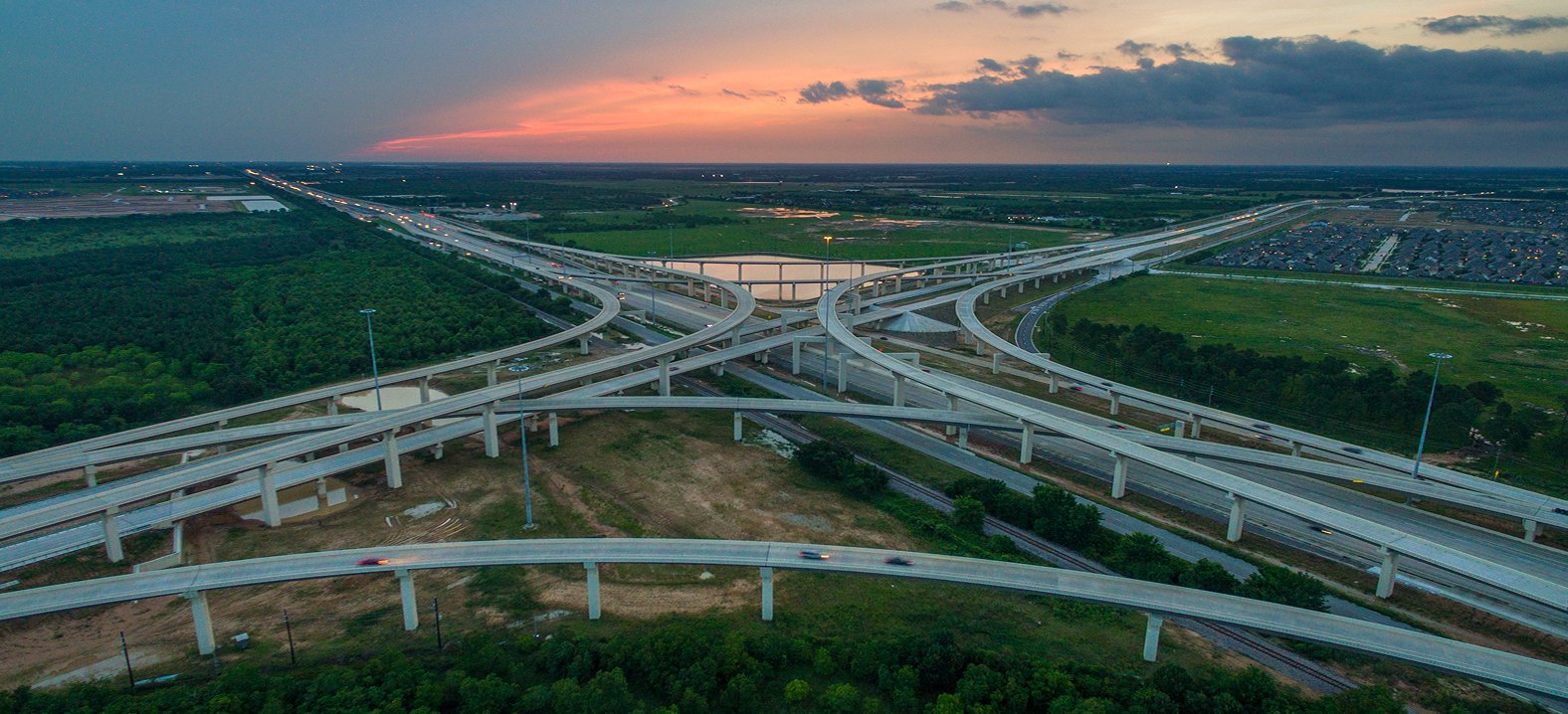 Aerial view of a large highway interchange at sunset