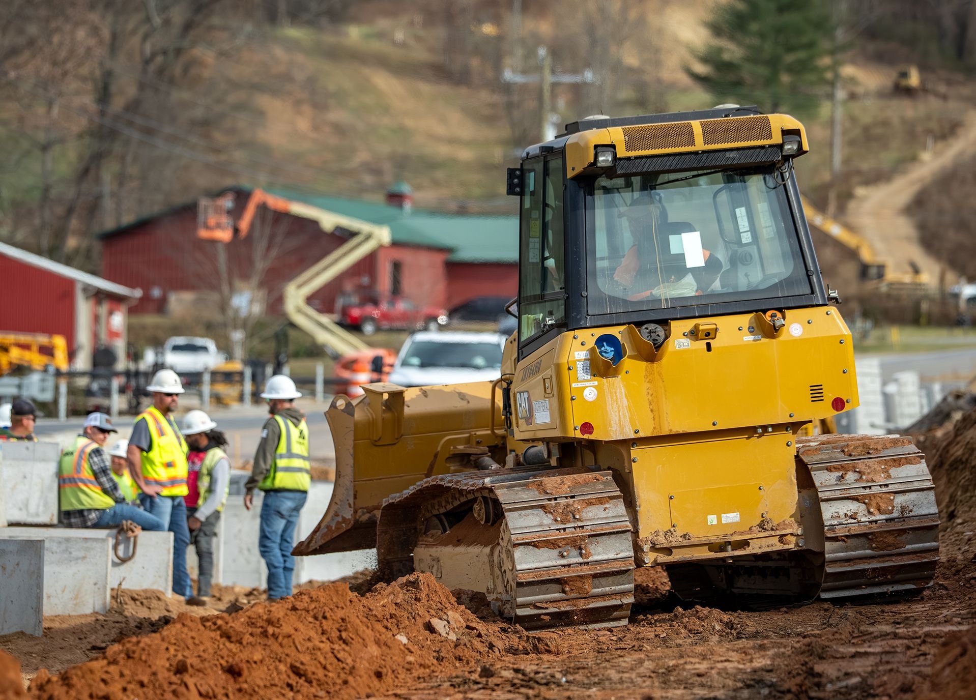 Zachry crew works alongside heavy equipment at an infrastructure construction site