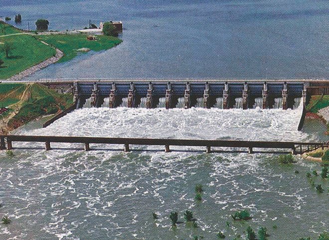 Aerial view of Lavon Dam with water flowing through its gates